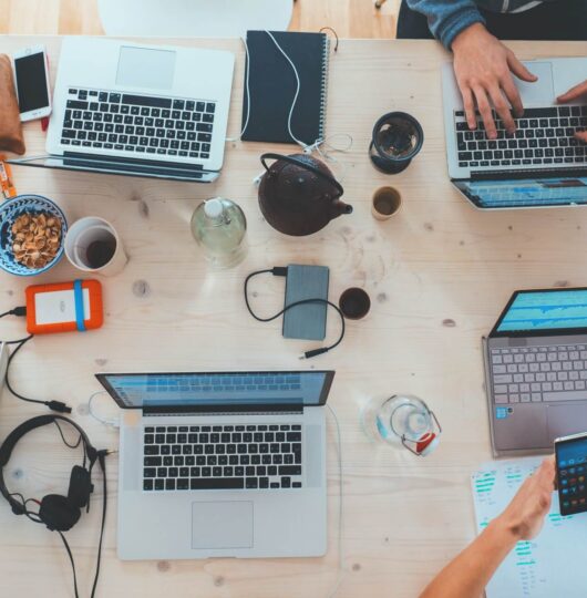 group-working-laptops-desk